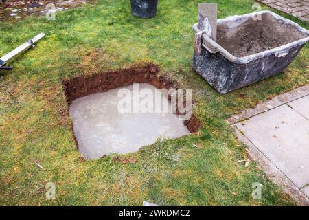 Pouring concrete slab for shed foundation for covering open terrace or patio Stock Photo