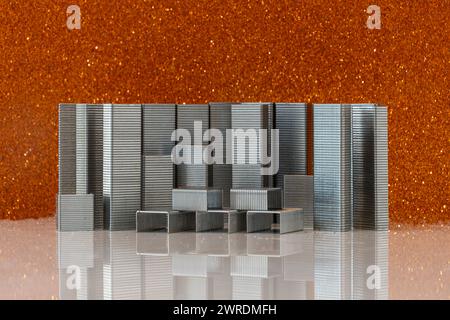 The staples on a bright red glossy surface Stock Photo