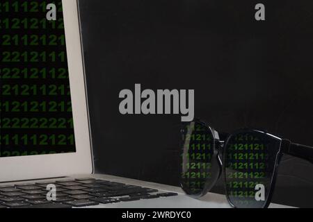 The reflection of stolen data on sunglasses indicating identity theft Stock Photo