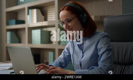 Caucasian smiling businesswoman business virtual meeting conference in office woman girl in headset communicate video call center operator talk Stock Photo