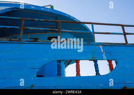 Superstructure detail of an abandoned and rotting old trawler moored in the marina at Roccella Ionica, Calabria, southern Italy Stock Photo