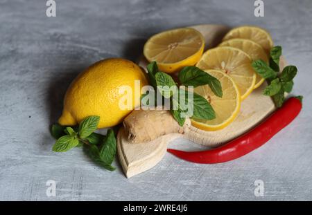 Lemons and mint leaves. Still life with organic fruit. Eating healthy concept. Natural antioxidants. Stock Photo