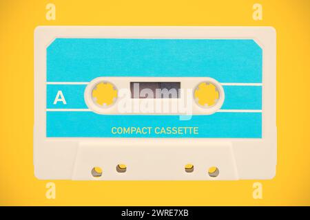 Vintage blue with white audio compact cassette in front of an orange background Stock Photo