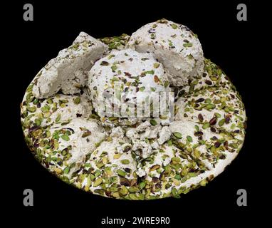 Sweet homemade pistachio nougat halva. Isolated on black Stock Photo