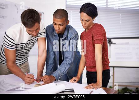 Group, drawing or architects with blueprint for discussion, serious or construction plan in creative startup. Collaboration, designers or diverse Stock Photo