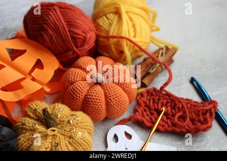 Flat lay composition with knitting accessories on grey background. Handmade decorations for Halloween. Space for text. Stock Photo