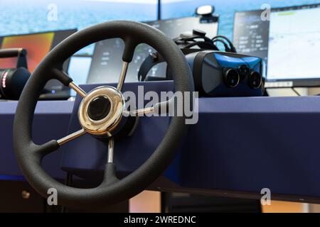 Marine navigation simulation system, ship control panel with steering wheel and VR headset on the desk Stock Photo