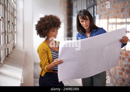 Business people, blueprints and planning for building design, architects and internship in office. Colleagues, communication and paperwork in creative Stock Photo
