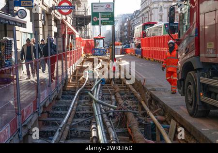 Road works in the West End of London, UK. Fibre fast internet cabling, telephone, water, sewage & water  and power cables all lie beneath London's crowded Streets causing traffic delays during maintenance work. Credit: Rob Taggart/Alamy Stock Photo