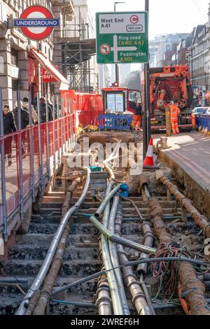 Road works in the West End of London, UK. Fibre fast internet cabling, telephone, water, sewage & water  and power cables all lie beneath London's crowded Streets causing traffic delays during maintenance work. Credit: Rob Taggart/Alamy Stock Photo