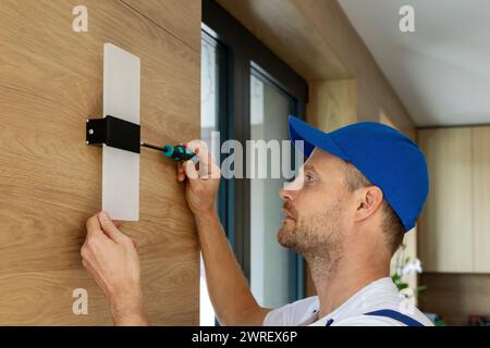 electrician installing led wall lamp at home. interior lighting Stock Photo