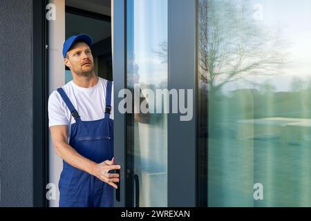 man installing aluminum frame sliding terrace doors Stock Photo