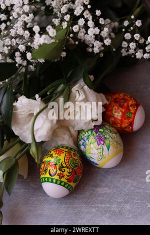 Decorated Easter eggs close up photo. Christian religion symbol. Holidays and celebration concept. Colorful eggs on textured background Stock Photo