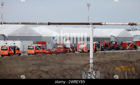 Berlin, Germany. 12th Mar, 2024. Firefighters are deployed to the refugee accommodation at the former Tegel Airport. The Berlin fire department has been deployed to a large-scale operation at the refugee accommodation at the former Tegel Airport. Credit: Carsten Koall/dpa/Alamy Live News Stock Photo