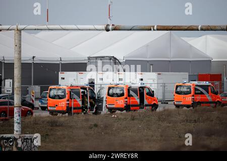 Berlin, Germany. 12th Mar, 2024. Firefighters are deployed to the refugee accommodation at the former Tegel Airport. The Berlin fire department has been deployed to a large-scale operation at the refugee accommodation at the former Tegel Airport. Credit: Carsten Koall/dpa/Alamy Live News Stock Photo