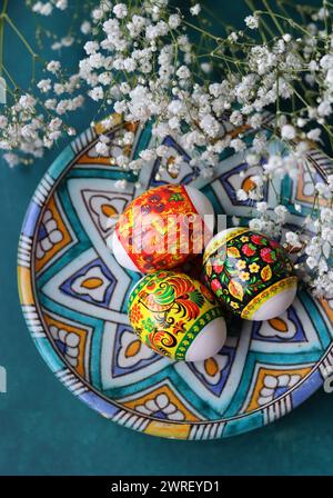 Easter greeting card. Colorful still life with eggs and flowers. Stock Photo