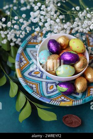 Easter celebration concept. Colorful still life with sweets. Textured background with copy space. Easter greeting card. Stock Photo