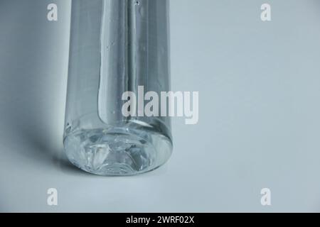A glass vase with water on a table Stock Photo