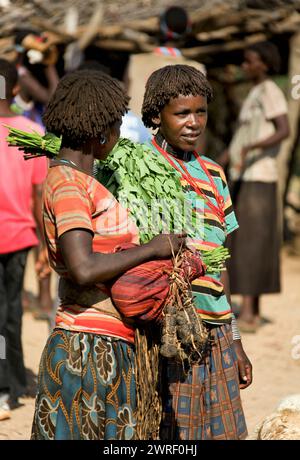 TURMI, OMO VALLEY, ETHIOPIA - NOVEMBER 19, 2011: Unidentified Hamar woman at village market. Weekly markets are important events in Omo Valley tribal Stock Photo