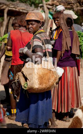 TURMI, OMO VALLEY, ETHIOPIA - NOVEMBER 19, 2011: Unidentified Hamar woman at village market. Weekly markets are important events in Omo Valley tribal Stock Photo