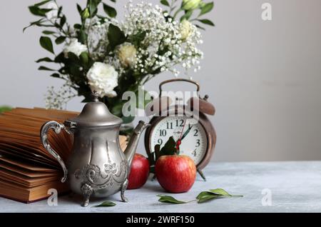 Retro styled still life with an open book on a desk. Close up photo of vintage objects. Stock Photo