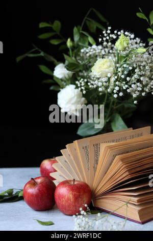 Retro styled still life with an open book on a desk. Close up photo of vintage objects. Stock Photo