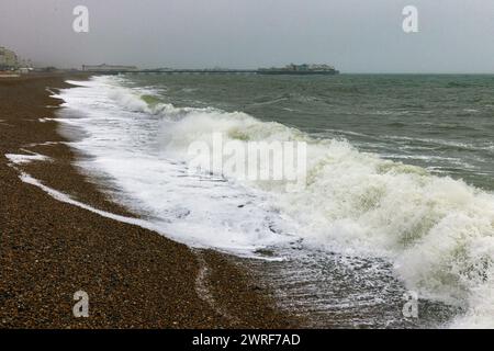 Brighton, City of Brighton & Hove, East Sussex, UK. High tide at the spring tide at Brighton Beach as the surge hits the sea defences. 12th March 2024. David Smith/Alamy Live News Stock Photo