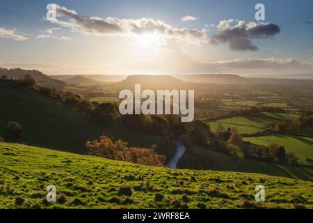 View to Cam Long Down and Cam Peak at sunset in autumn viewed from Coaley Peak viewpoint, Dursley, Cotswolds, Gloucestershire, England, United Kingdom Stock Photo