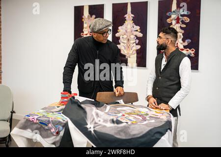 Jay Blades talks with textile artist Palvinder Nangla at the Pickle Factory in Bermondsey, south London, ahead of the opening of a pop-up showcasing a new generation of makers. The Jay & Co pop-up showcase will run from March 15 to 17. Picture date: Tuesday March 12, 2024. Stock Photo