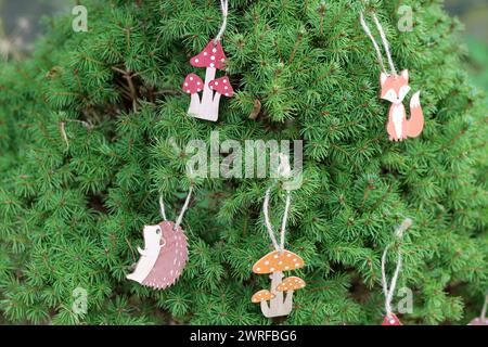 Decorated Christmas tree outdoor photo. Handmade Christmas decorations made of wood. Stock Photo