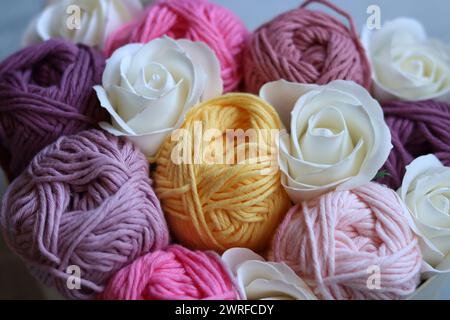 Bouquet made of cotton yarn balls  in a wooden box. Colorful photo of soft pink organic yarn. Hobbies and leisure concept. Stock Photo