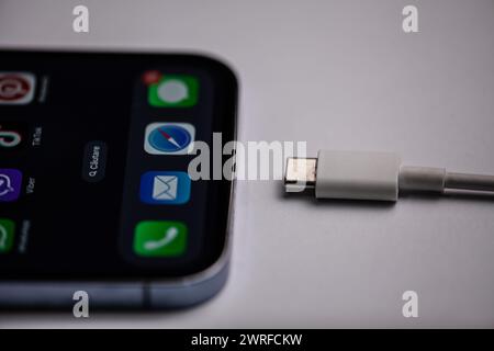The new iphone with menu picture with type-c charger on a gray background. Moldova,Hincesti 04.09.2023 Stock Photo