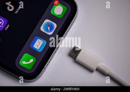 USB type C port cable for charging to the smartphone on blue background.Moldova, Hincesti, 04.09.2023 Stock Photo