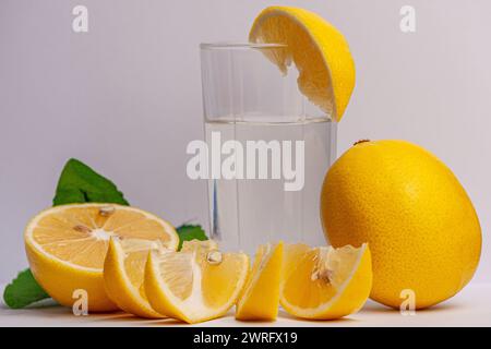 The picture of the lemon fruit, cut into several slices, gives us an appetite to eat this fruit, lemon has a very important role in human life, a glas Stock Photo