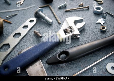 Close up of tools, screws and other metal hardware on a work bench Stock Photo
