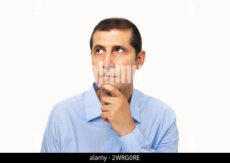 Business man over isolated background with hand on chin thinking about question, pensive expression. Smiling with thoughtful face. Doubt concept. Stock Photo