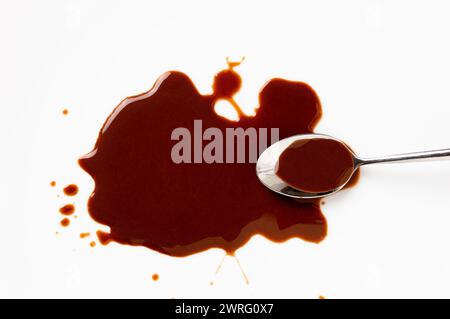 Chocolate sauce and spoon isolated on white Stock Photo