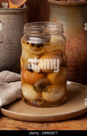 Hard-boiled chicken eggs are pickled in vinegar with spices. .The eggshells are crushed and the jar refrigerated about for a week Stock Photo