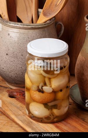 Hard-boiled chicken eggs are pickled in vinegar with spices. .The eggshells are crushed and the jar refrigerated about for a week Stock Photo
