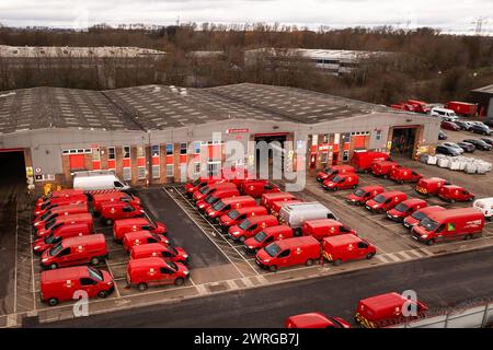 LEEDS, UK - FEBRUARY 16, 2024.  Aerial view of a fleet of parked Royal Mail and Post Office delivery vehicles parked at a depot Stock Photo