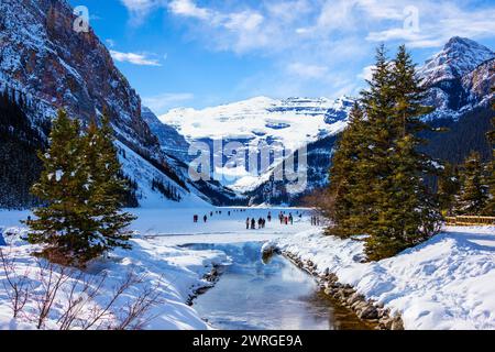 Frozen Lake Louise in the winter against the backdrop of the stunning Victoria Glacier. The iconic Lake Louise typically freezes from November to mid- Stock Photo