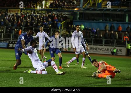 Harry Lewis of Carlisle United saves as Devante Cole of Barnsley pressures during the Sky Bet League 1 match Carlisle United vs Barnsley at Brunton Park, Carlisle, United Kingdom, 12th March 2024  (Photo by Mark Cosgrove/News Images) Stock Photo