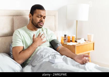 Unhealthy african american man doing morning checkup after waking up Stock Photo