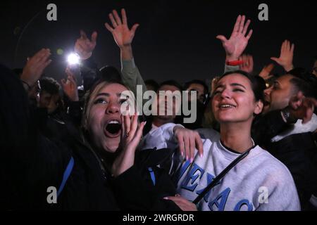 March 12, 2024, Tehran, Iran: Two Iranian young women without covering their mandatory Islamic headscarf dance on the eve of Wednesday's traditional Fire feast, or Chaharshanbeh Soori, held annually on the last Wednesday eve before the Spring holiday of Nowruz, in Tehran. The Iranian New Year (Nowruz) which begins on March 20 coincides with the first day of spring during which locals revive the Zoroastrian celebration of lighting a fire and dancing around the flame. Nowruz, which has been celebrated for at least three thousand years, is the most revered celebration in the Greater Persian world Stock Photo