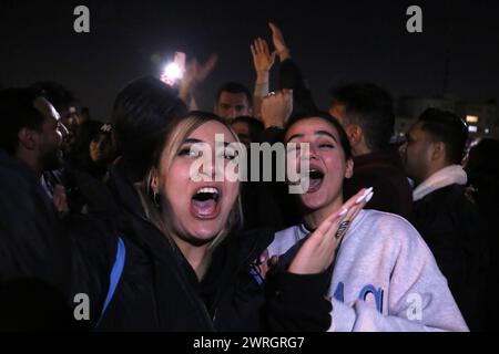 March 12, 2024, Tehran, Iran: Two Iranian young women without covering their mandatory Islamic headscarf dance on the eve of Wednesday's traditional Fire feast, or Chaharshanbeh Soori, held annually on the last Wednesday eve before the Spring holiday of Nowruz, in Tehran. The Iranian New Year (Nowruz) which begins on March 20 coincides with the first day of spring during which locals revive the Zoroastrian celebration of lighting a fire and dancing around the flame. Nowruz, which has been celebrated for at least three thousand years, is the most revered celebration in the Greater Persian world Stock Photo