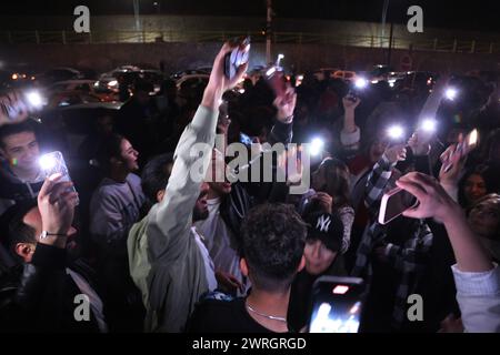 March 12, 2024, Tehran, Iran: Iranian youth dance on the eve of Wednesday's traditional Fire feast, or Chaharshanbeh Soori, held annually on the last Wednesday eve before the Spring holiday of Nowruz, in Tehran. The Iranian New Year (Nowruz) which begins on March 20 coincides with the first day of spring during which locals revive the Zoroastrian celebration of lighting a fire and dancing around the flame. Nowruz, which has been celebrated for at least three thousand years, is the most revered celebration in the Greater Persian world, which includes the countries of Iran, Afghanistan, Azerbaij Stock Photo