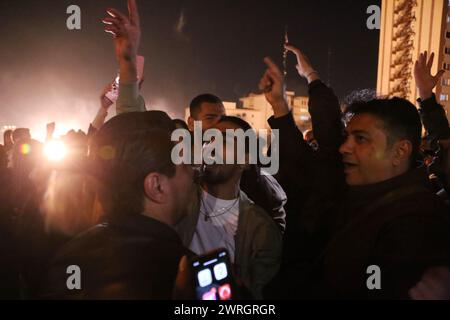 March 12, 2024, Tehran, Iran: Iranian youth dance on the eve of Wednesday's traditional Fire feast, or Chaharshanbeh Soori, held annually on the last Wednesday eve before the Spring holiday of Nowruz, in Tehran. The Iranian New Year (Nowruz) which begins on March 20 coincides with the first day of spring during which locals revive the Zoroastrian celebration of lighting a fire and dancing around the flame. Nowruz, which has been celebrated for at least three thousand years, is the most revered celebration in the Greater Persian world, which includes the countries of Iran, Afghanistan, Azerbaij Stock Photo