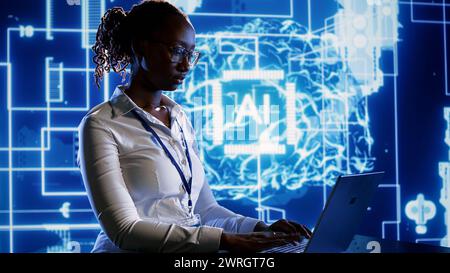 Trained specialist using laptop to maintenance artificial intelligence neural networks made up of interconnected nodes. System administrator using AI system aiding in processing information Stock Photo