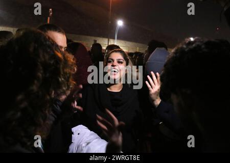 Tehran, Iran. 12th Mar, 2024. An Iranian young woman without covering her mandatory Islamic headscarf dances on the eve of Wednesday's traditional Fire feast, or Chaharshanbeh Soori, held annually on the last Wednesday eve before the Spring holiday of Nowruz, in Tehran. The Iranian New Year (Nowruz) which begins on March 20 coincides with the first day of spring during which locals revive the Zoroastrian celebration of lighting a fire and dancing around the flame. Nowruz, which has been celebrated for at least three thousand years, is the most revered celebration in the Greater Persian world, Stock Photo