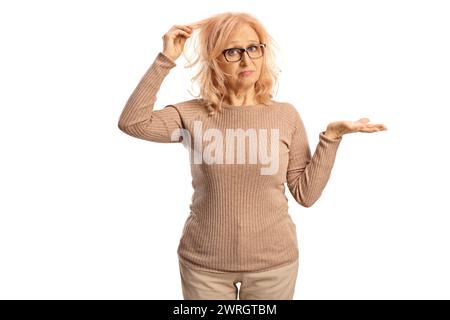 Middle aged woman disappointed with her hair isolated on white background Stock Photo